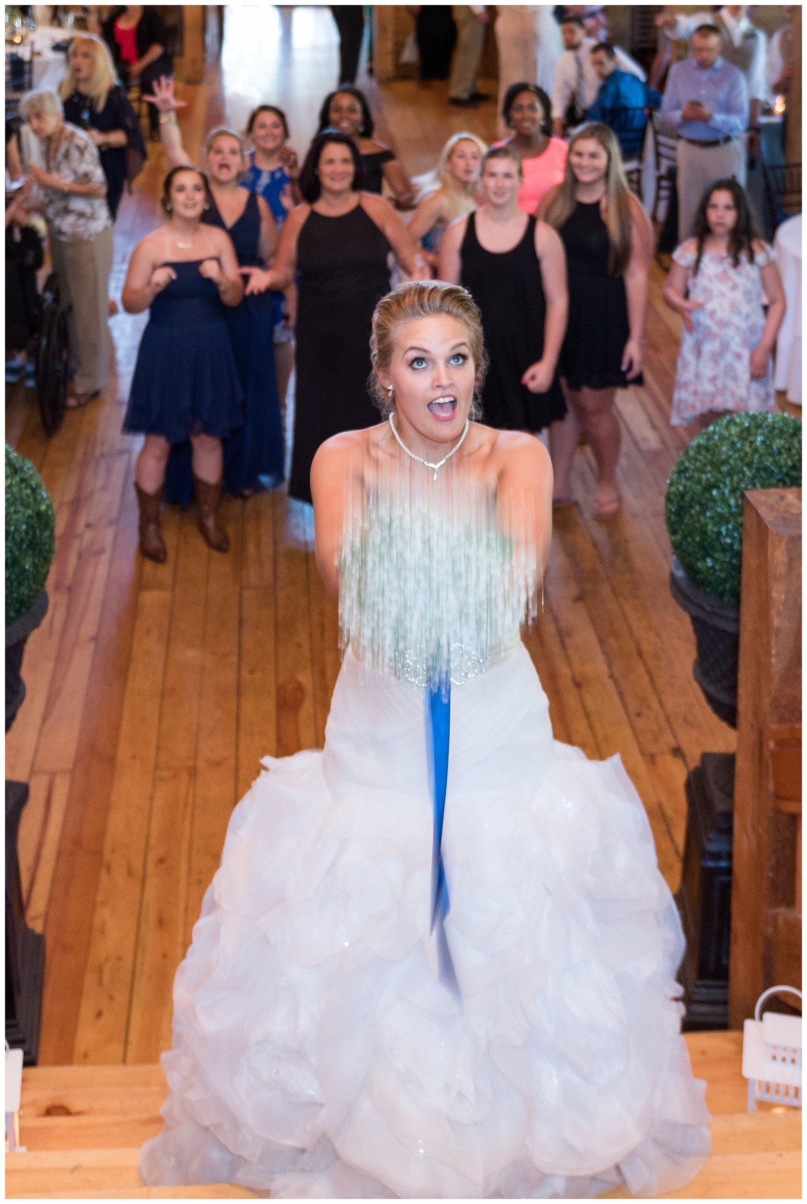 Bride tossing bouquet to bridesmaids at red lion inn wedding in Cohasset