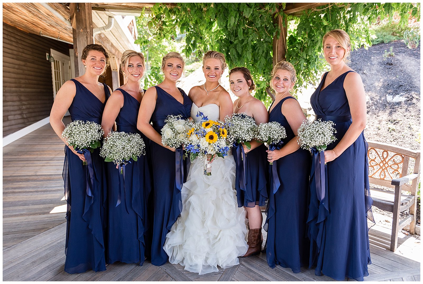 Bride and her navy bridesmaids with baby's breath bouquets at a red lion inn wedding
