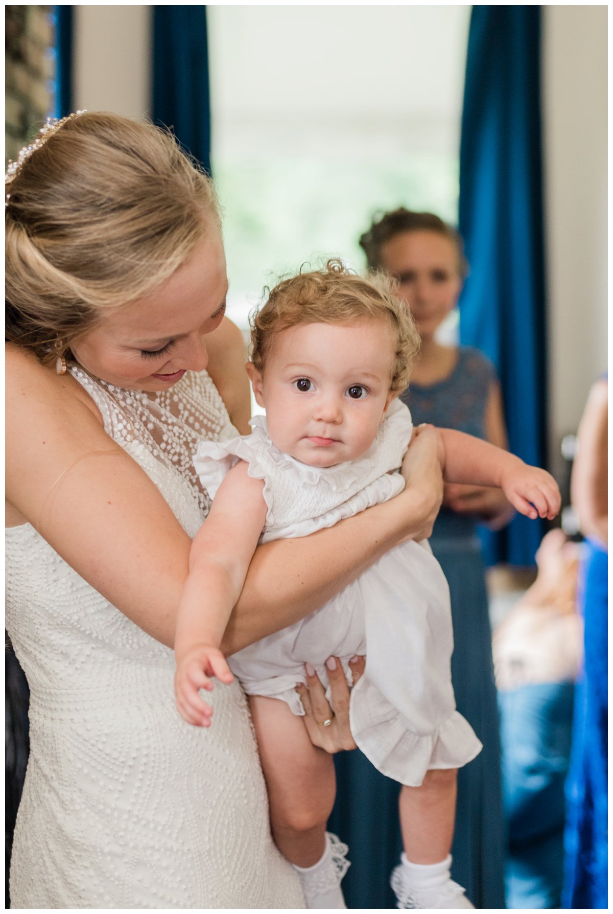 bride with her niece, the flower girl, in the bridal cabin before the wedding ceremony