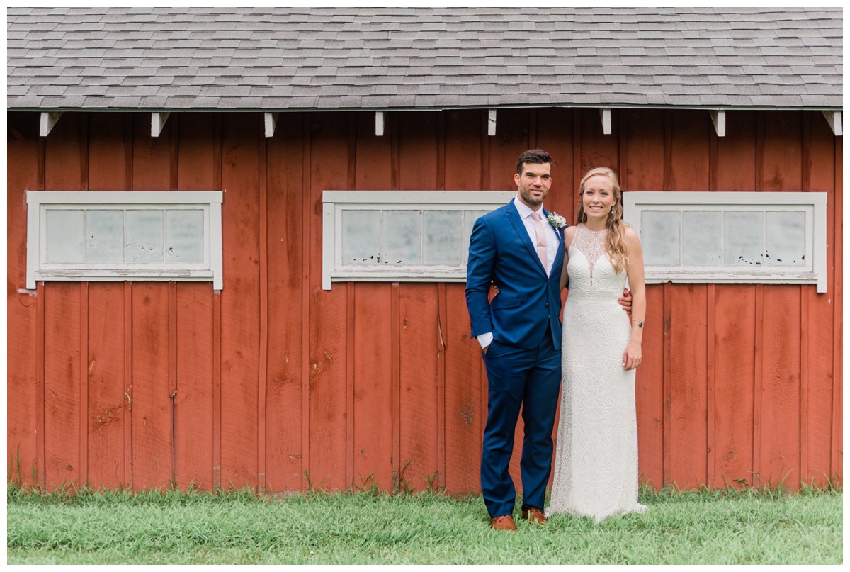 bride and groom red barn portrait