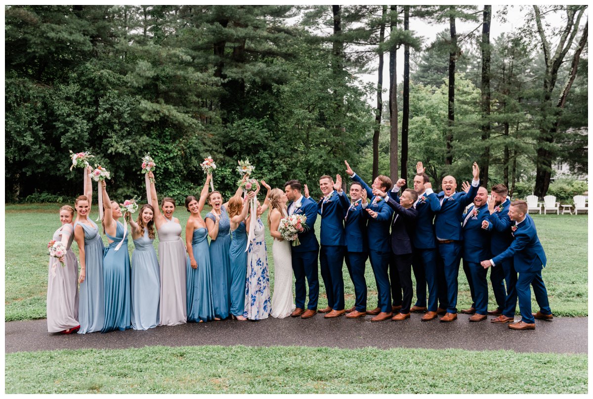 Warren Conference wedding party formal photo bride and groom kissing bridesmaids and groomsmen cheering