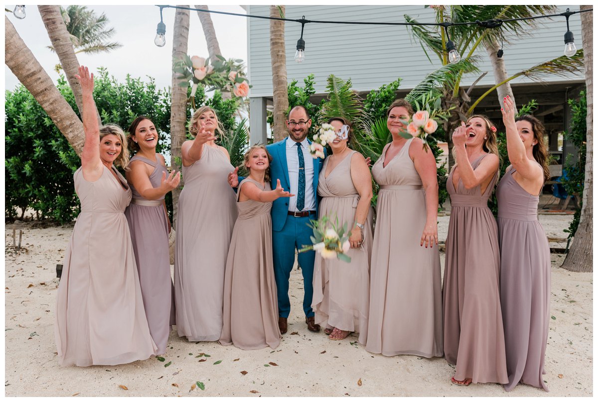 bridesmaids tossing bouquets on the beach in florida