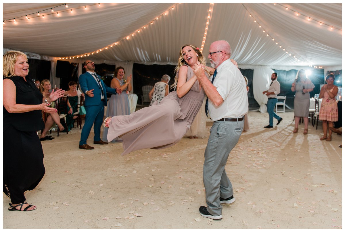 A father and daughter dance at an outdoor wedding reception in florida
