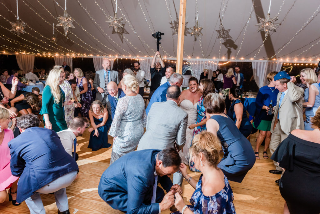 getting down dancing at the wedding reception under the tent