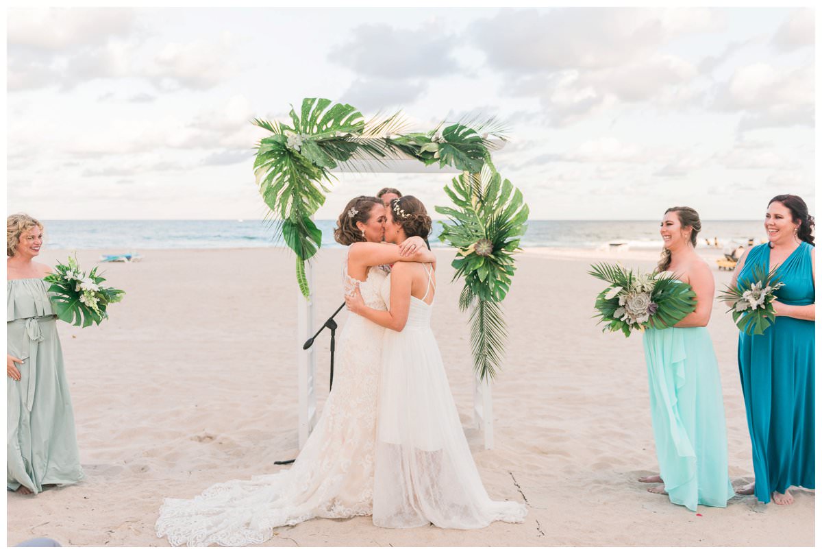 first kiss at ceremony on the beach at hilton singer island
