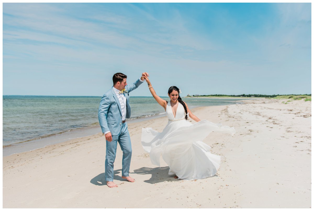 A bride and groom pose for a photo on a beach in West Falmouth following their intimate Cape Cod wedding ceremony