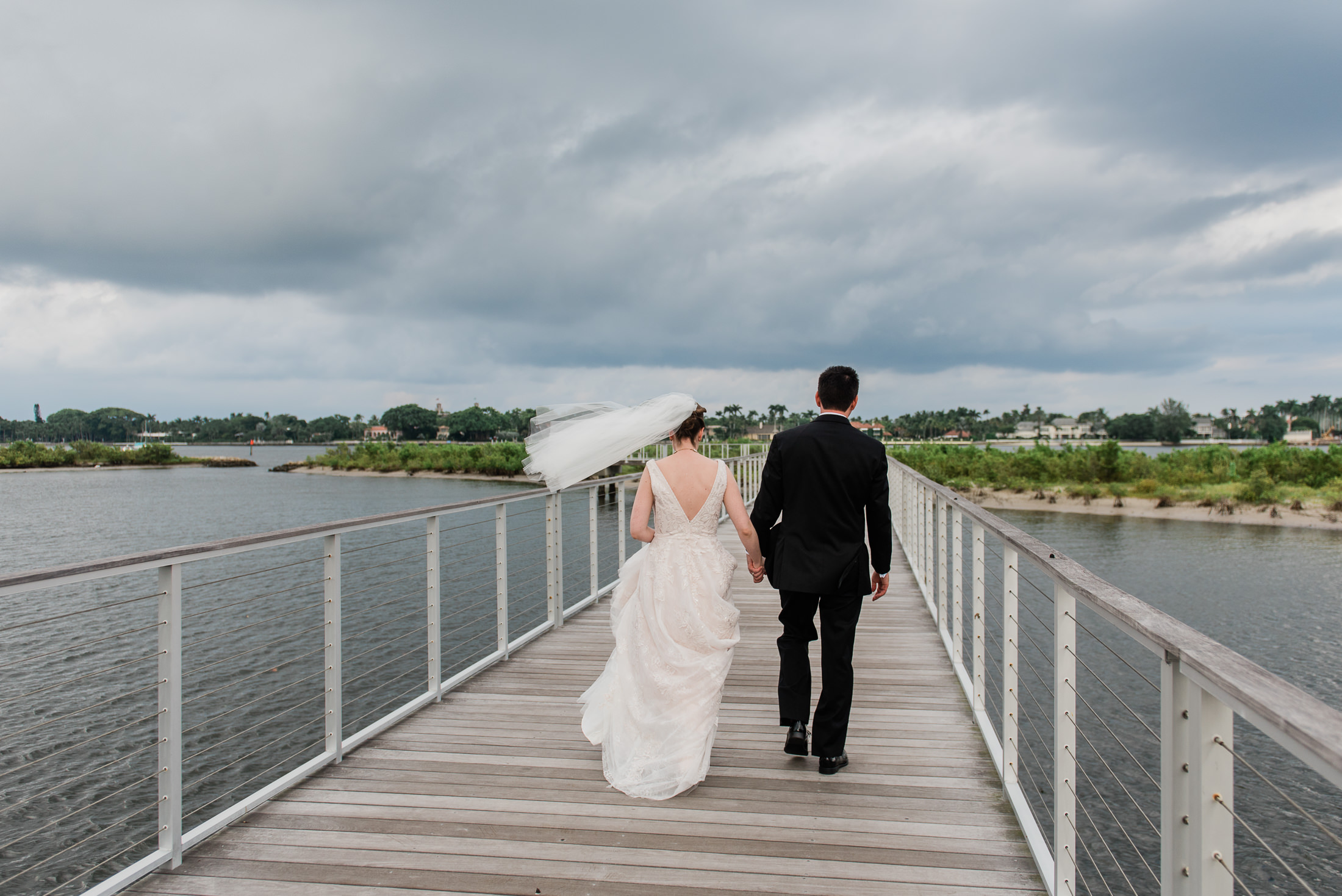 bride and groom portraits in west palm beach despite a looming thunderstorm
