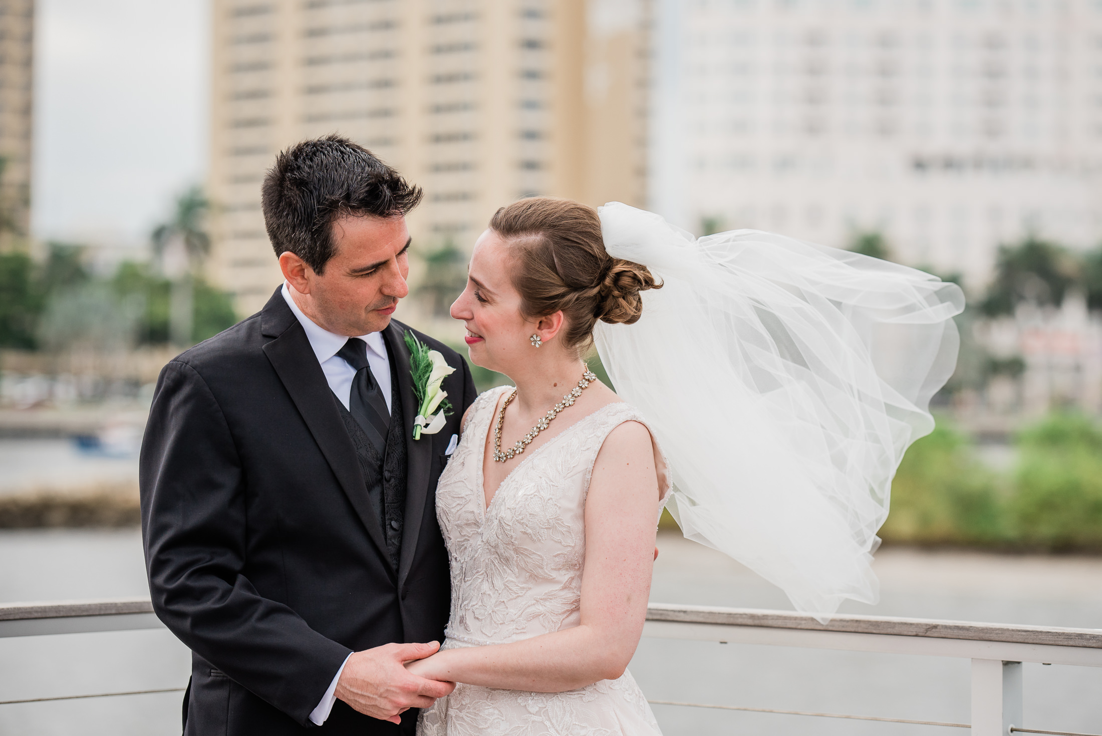 bride and groom portraits on a pier in downtown west palm beach