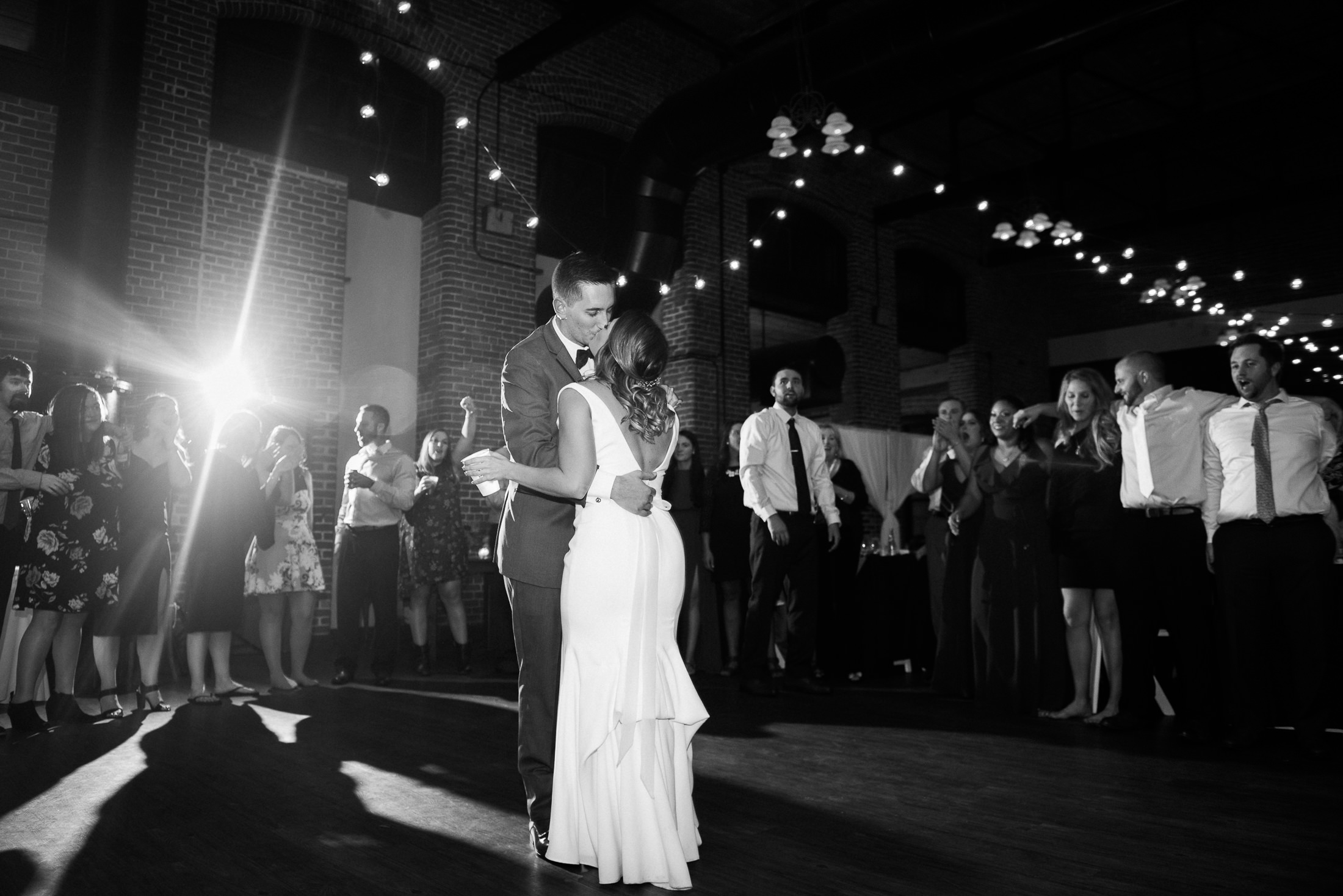 bride and groom dance surrounded by friends at Charles River Museum of Industry and Innovation wedding