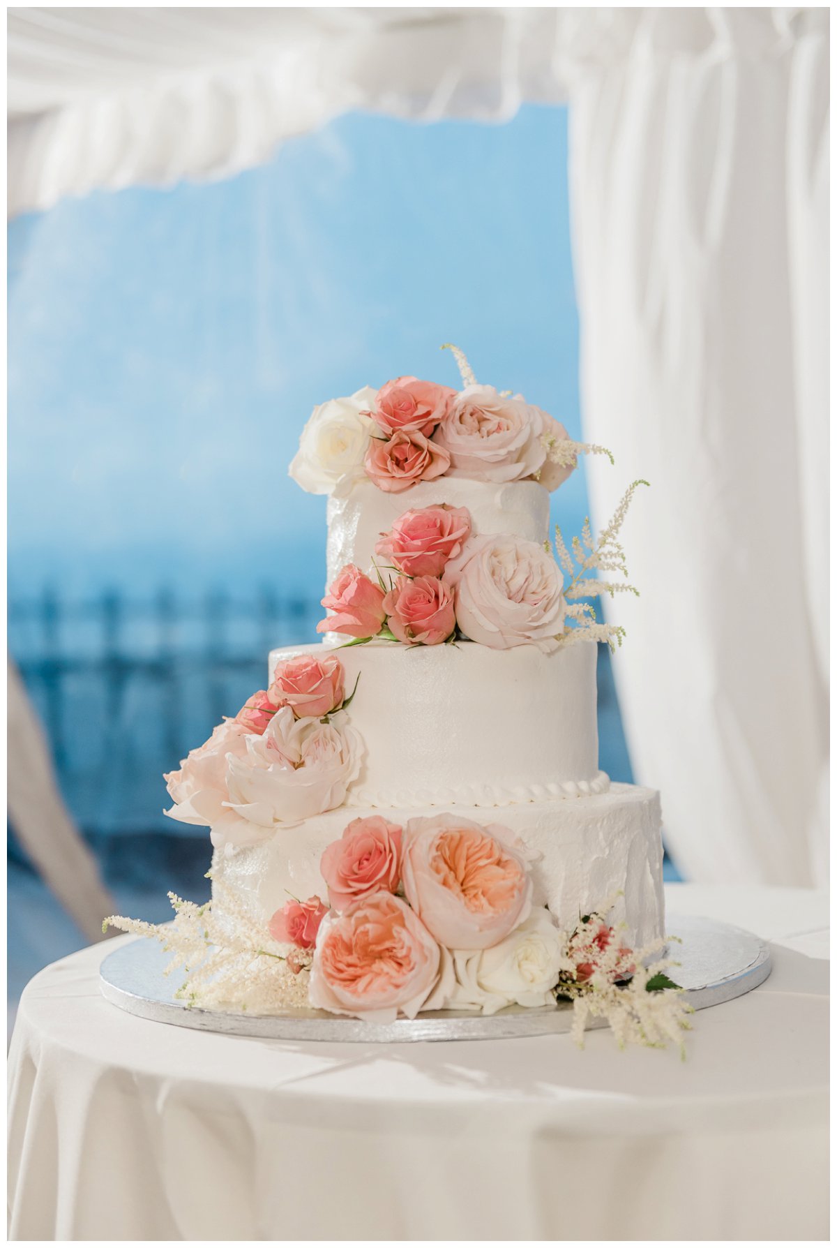 the wedding cake at an outdoor beach wedding reception in florida